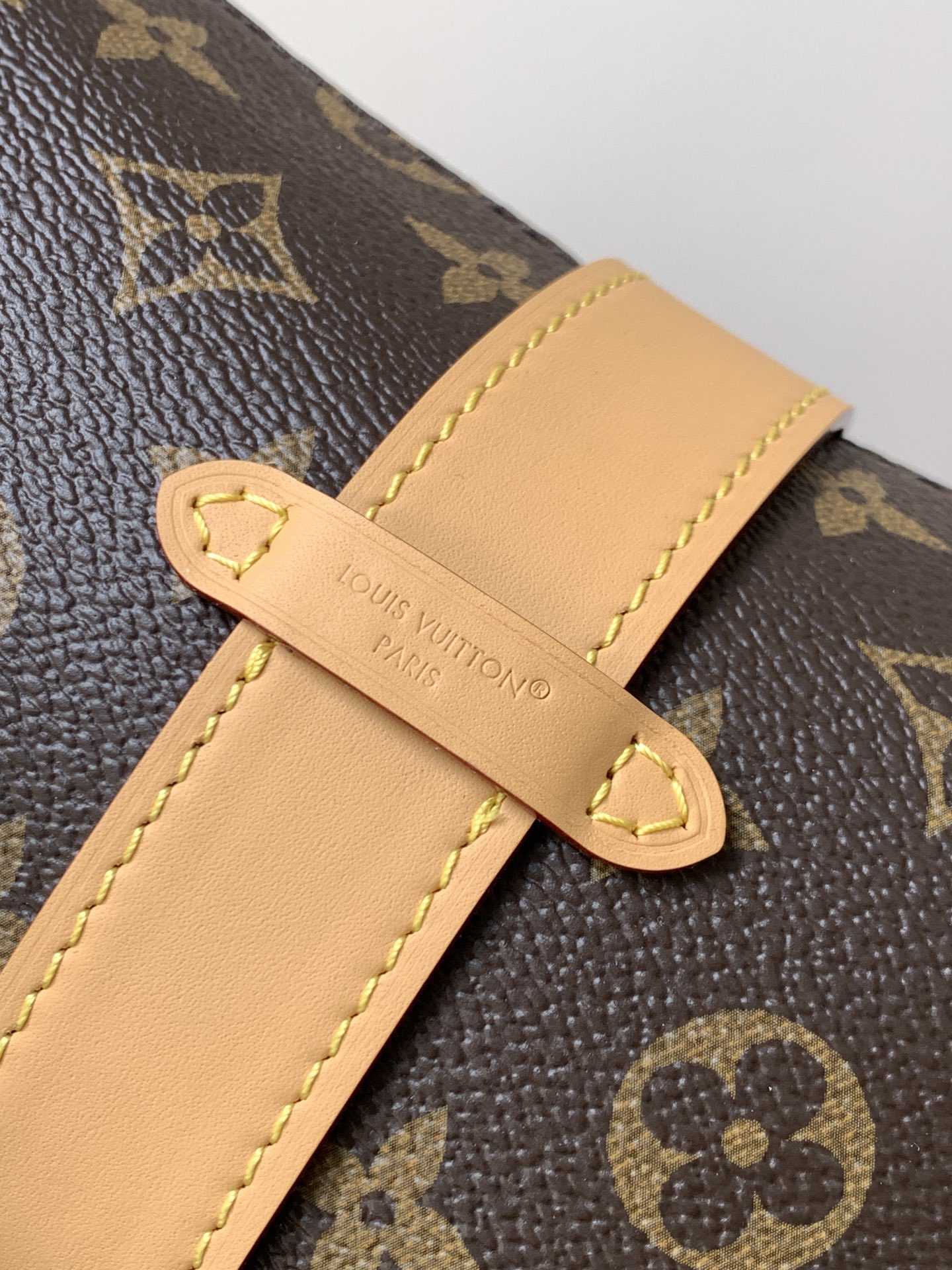 Louis Vuitton This Pochette Mia handbag, part of the Monogram collection, features a Monogram canvas body accented with cowhide leather trim.