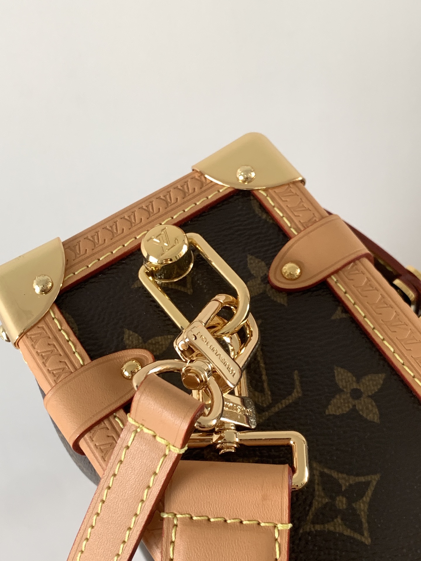 Louis Vuitton This large Side Trunk handbag features Monogram canvas accented with contrasting leather trim.