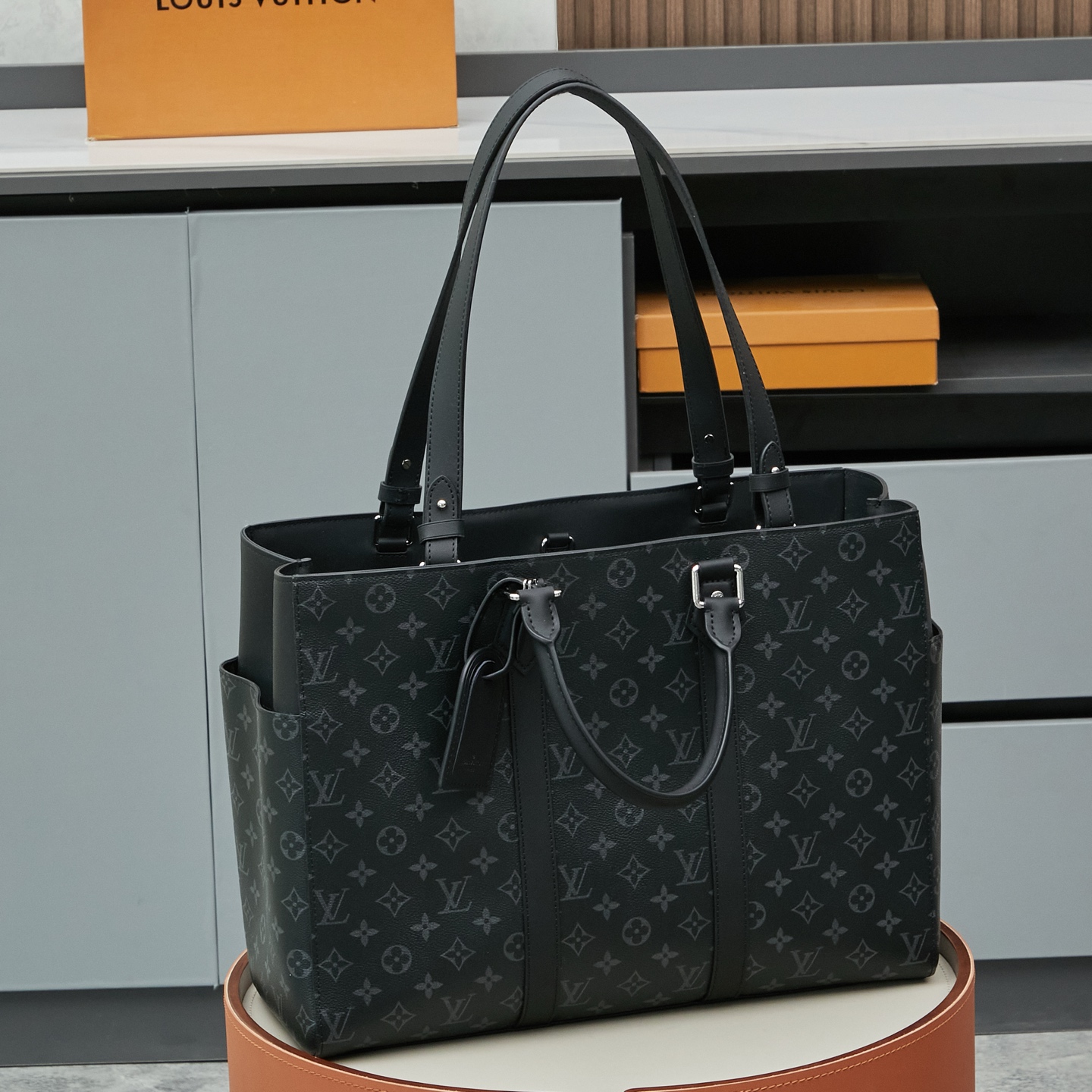 Louis Vuitton M46451 Black Monogram: A spacious handbag from the Sac Plat collection, the Sac Plat 24H features leather trim.