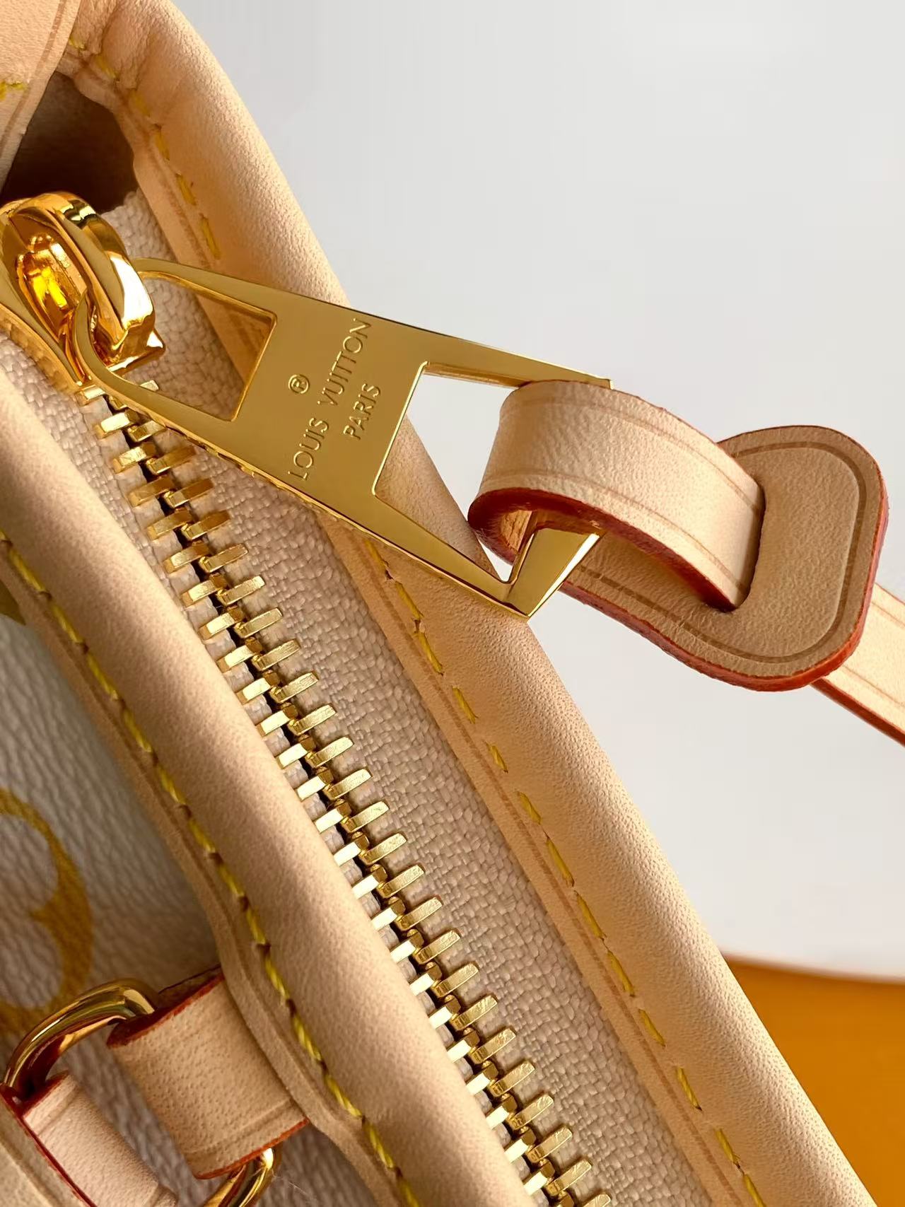 Louis Vuitton This Carryall East-West canvas handbag illuminates this classic element with a vibrant splash of color.