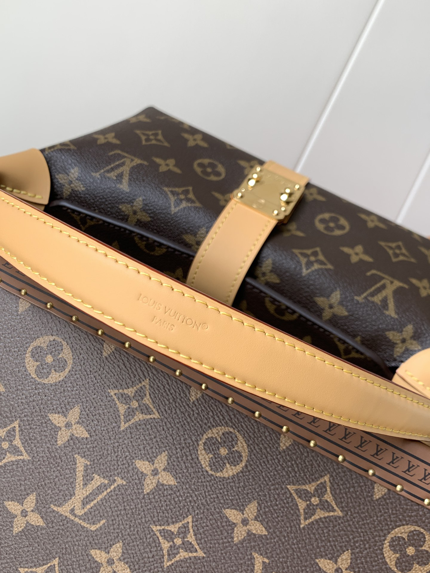 Louis Vuitton This Pochette Mia handbag, part of the Monogram collection, features a Monogram canvas body accented with cowhide leather trim.