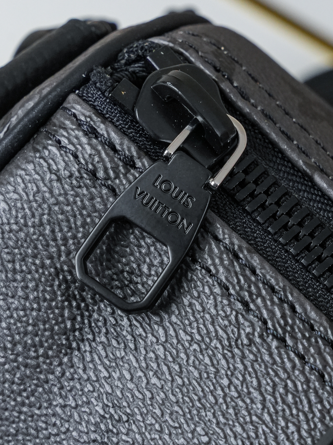 Louis Vuitton This Keell Bandoulière 25 handbag features Monogram Midnight coated canvas accented with a deep Monogram print.