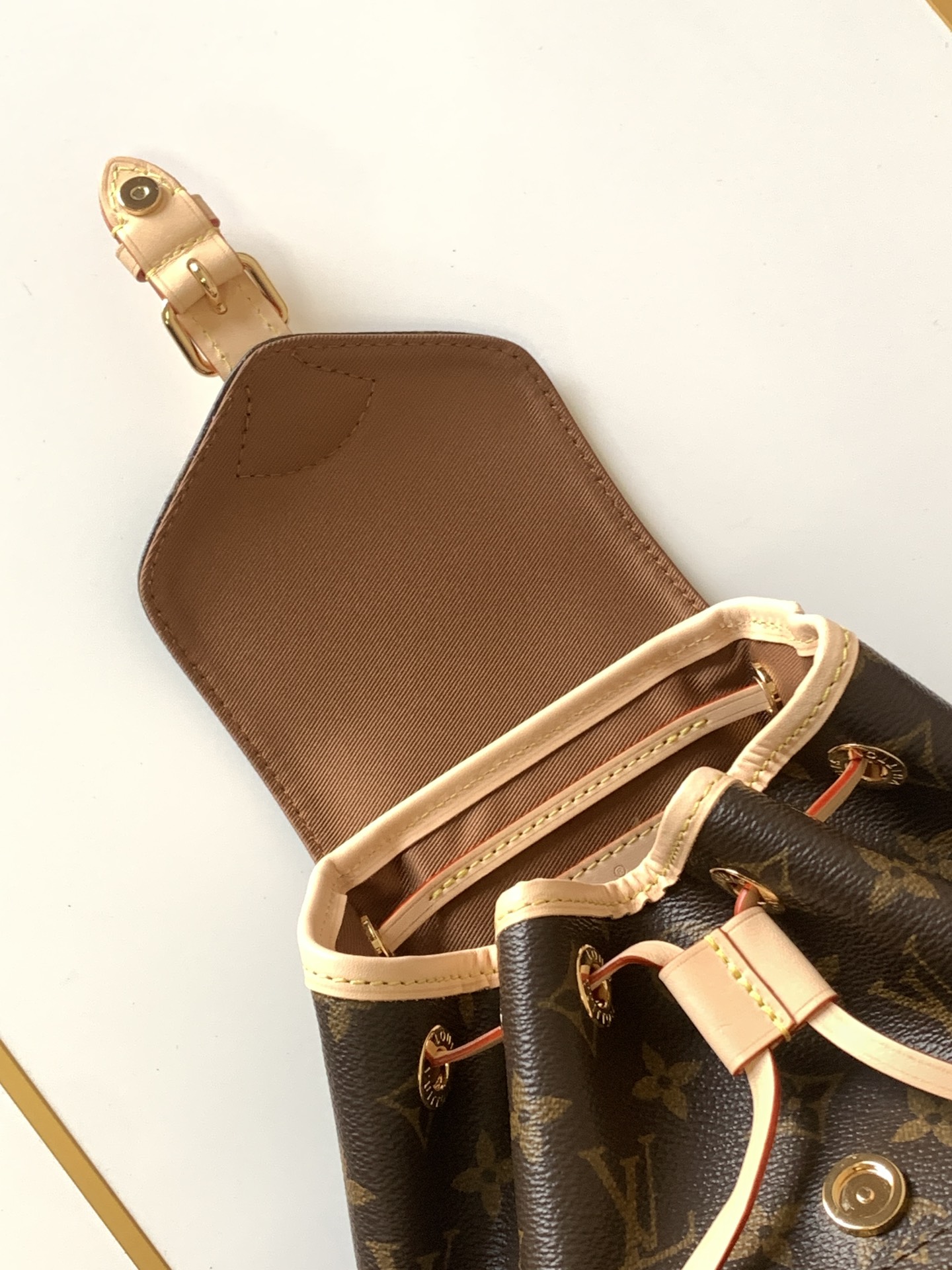 Louis Vuitton This Montsouris Mini features Monogram coated canvas with cowhide leather trim.