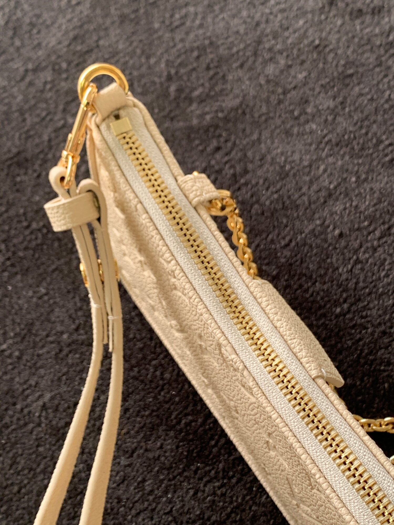 Louis Vuitton The Easy Pouch On Strap handbag from the Spring 2022 Collection is crafted from Monogram Empreinte leather.