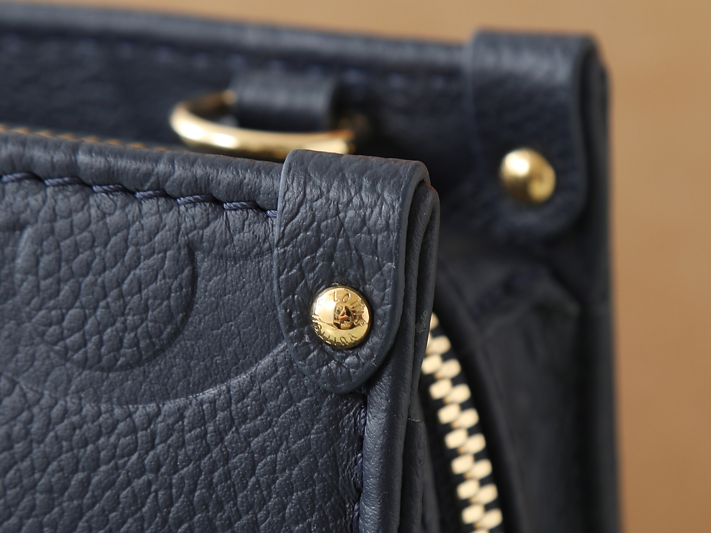 Louis Vuitton M23640 Deep Blue Embossed: This small OnTheGo handbag is crafted from Monogram Empreinte leather, embossed with the Giant Monogram pattern.