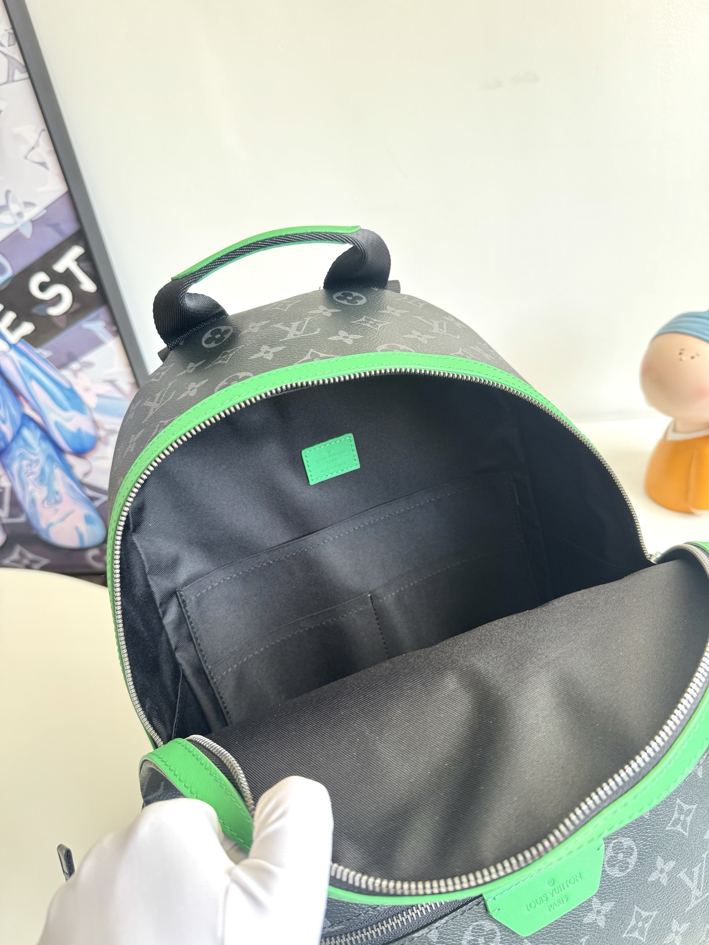 Louis Vuitton This small Discovery backpack features a patchwork of Monogram Eclipse canvas and vibrant cowhide leather.