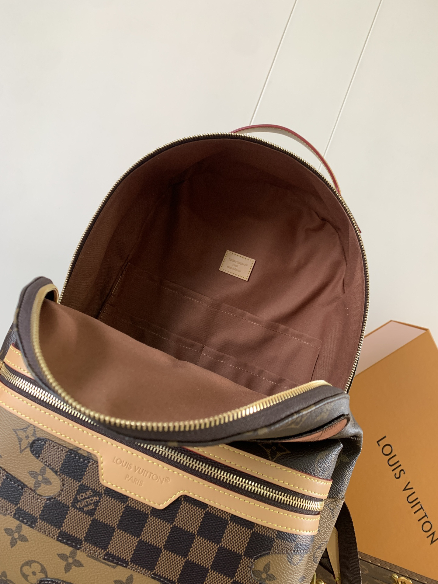 Louis Vuitton This Discovery Small Backpack features Monogram canvas accented with Monogram Reverse and Damier canvas patches.