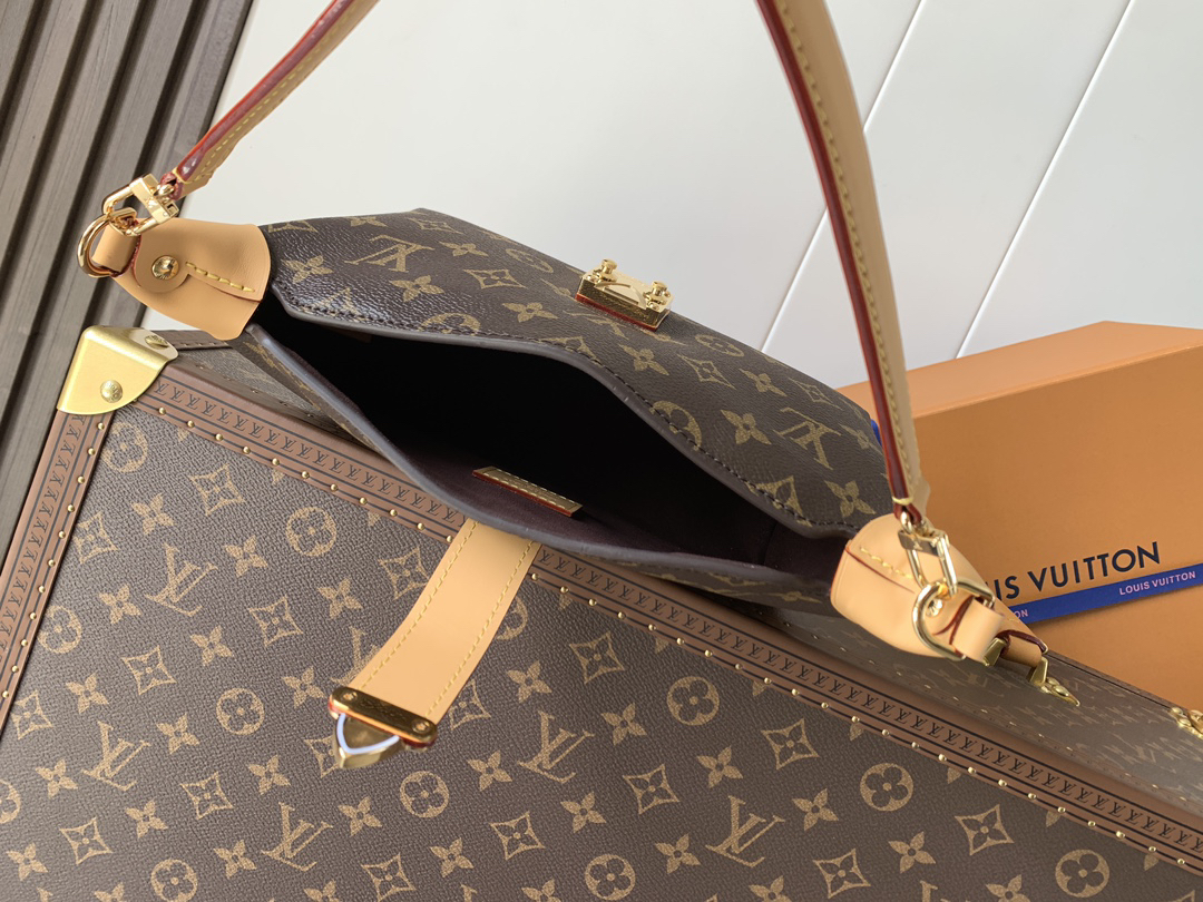 Louis Vuitton This Pochette Mia handbag, part of the Monogram collection, features a Monogram canvas body accented with cowhide leather trim.