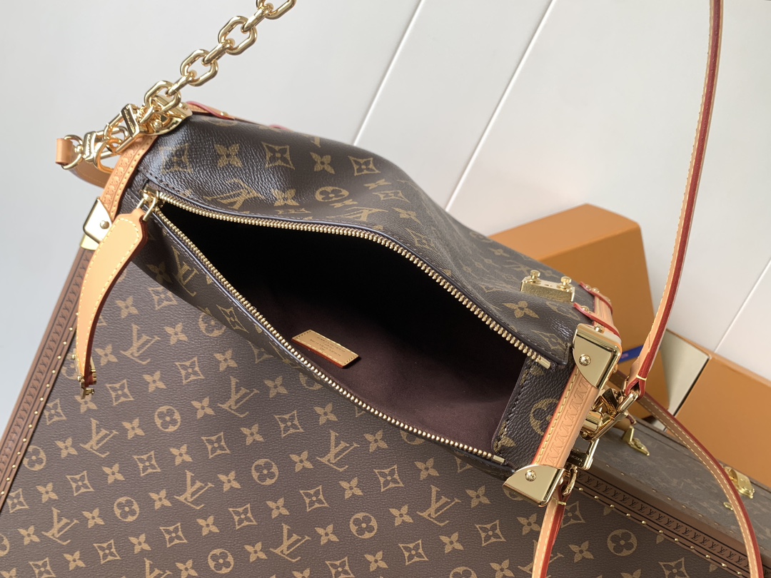 Louis Vuitton This large Side Trunk handbag features Monogram canvas accented with contrasting leather trim.