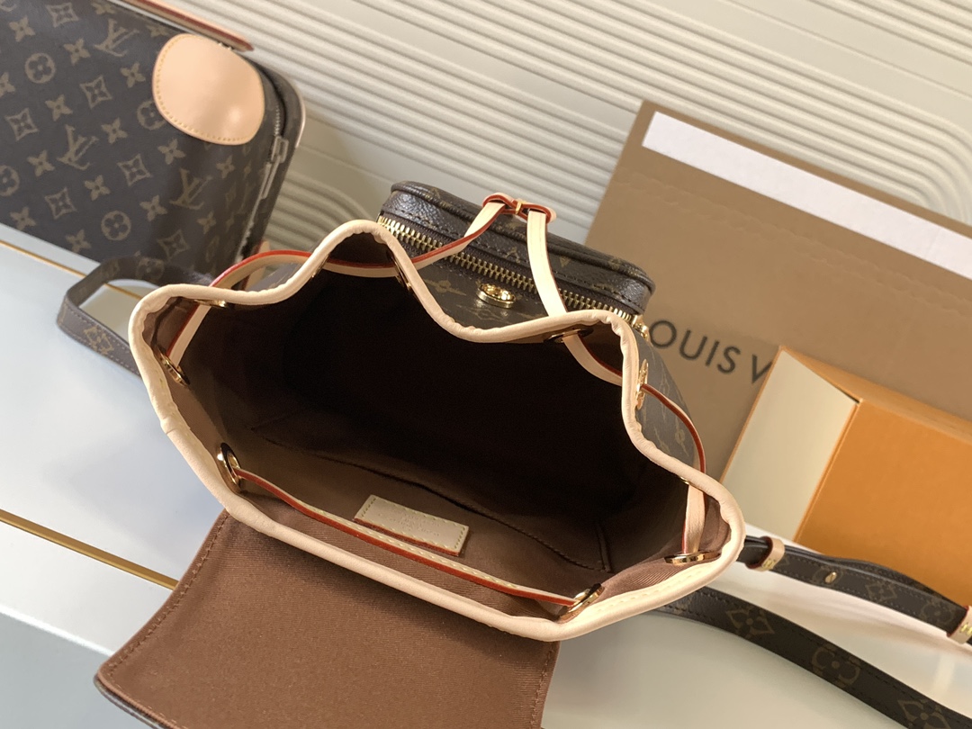 Louis Vuitton This Montsouris Mini features Monogram coated canvas with cowhide leather trim.