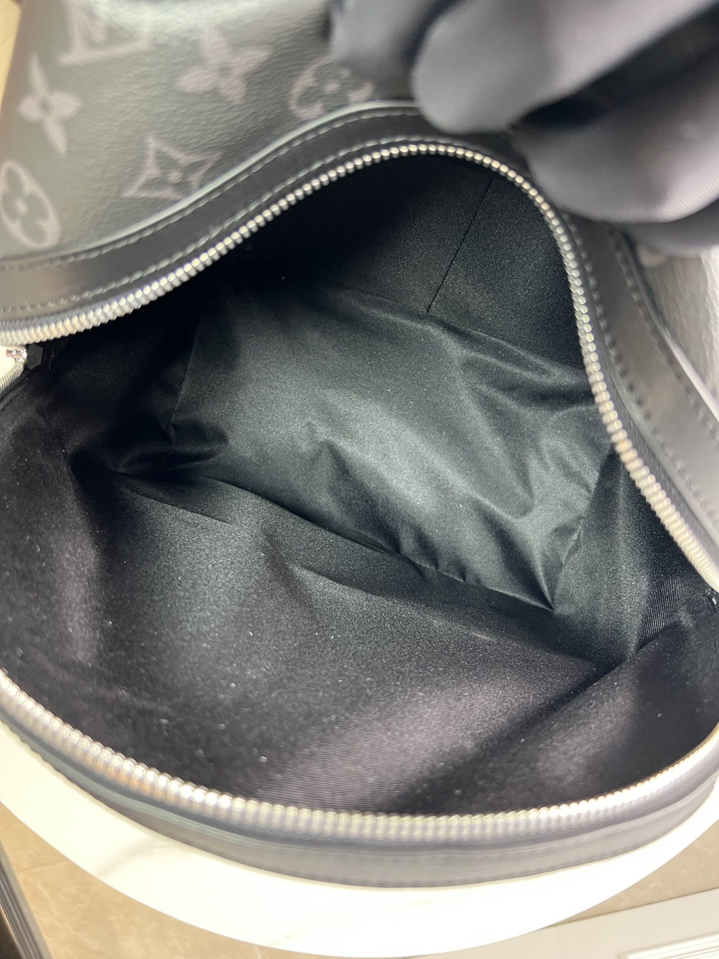 Crafted from Monogram Eclipse canvas, this small Discovery backpack retains its versatile functionality in a more compact silhouette.