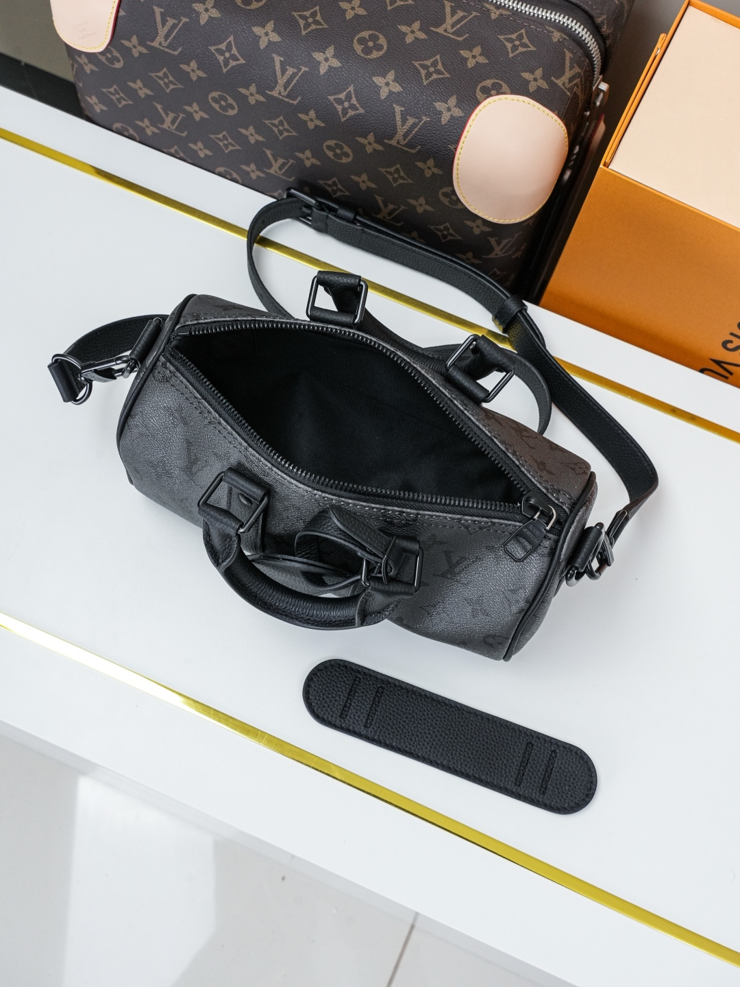 Louis Vuitton This Keell Bandoulière 25 handbag features Monogram Midnight coated canvas accented with a deep Monogram print.