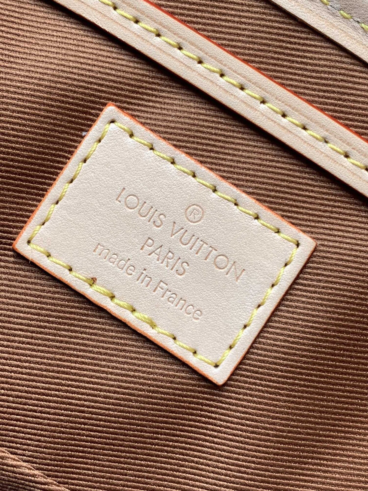 Louis Vuitton This Montsouris Mini features Monogram coated canvas with cowhide leather trim.