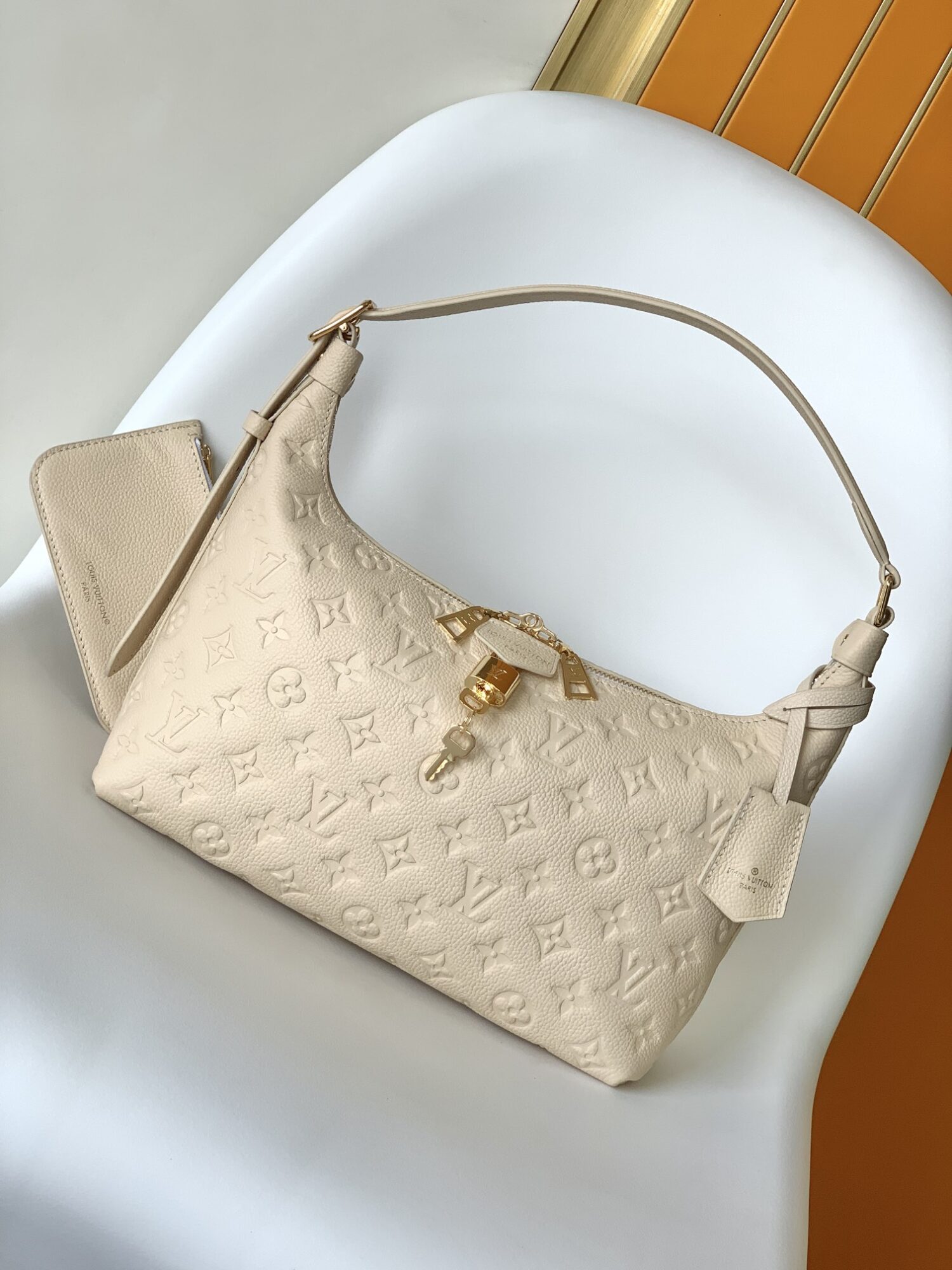 Louis Vuitton The Sac Sport handbag features a curved silhouette crafted from supple Monogram Empreinte embossed leather.
