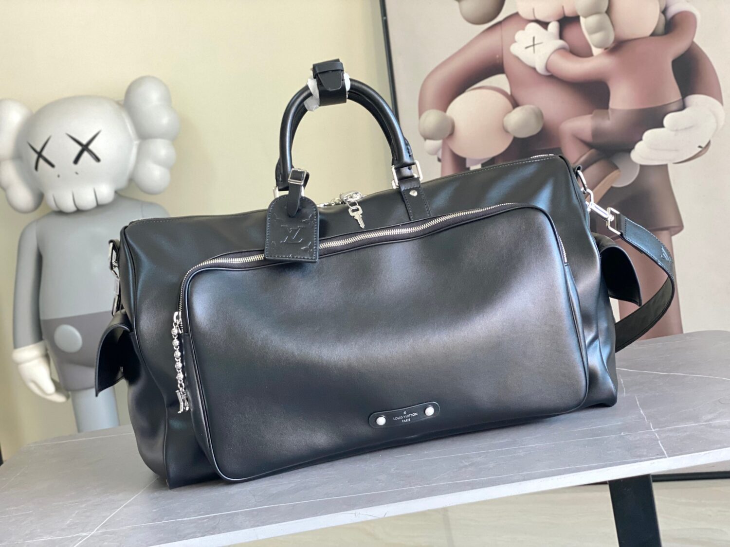 Louis Vuitton M13992 This Keepall Bandoulière 50 travel bag features a Monogram pattern on its canvas surface.