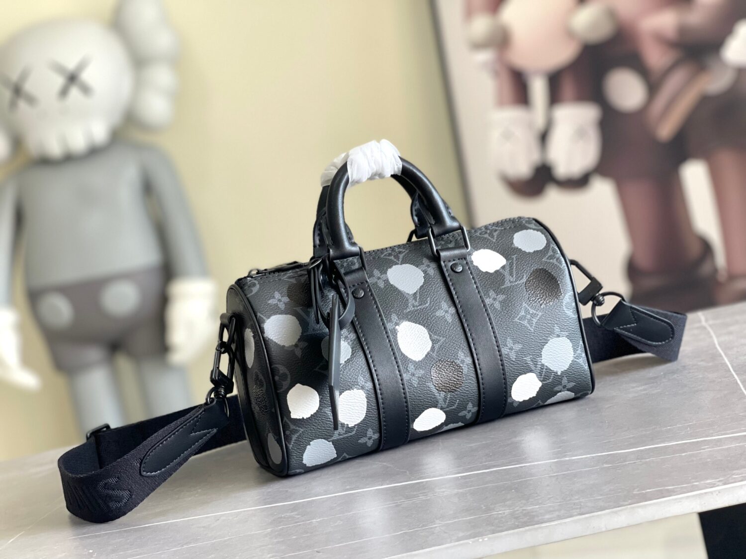 Louis Vuitton M46406 Black Floral Polka Dot Yayoi Kusama Handbag: This handbag encapsulates the classic silhouette of a travel bag and is crafted from embossed leather.