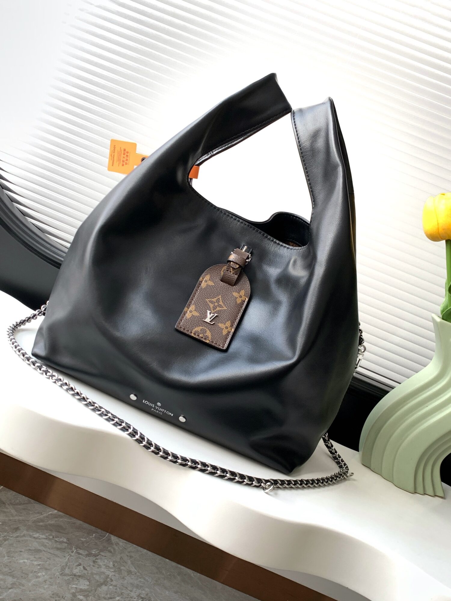 Louis Vuitton The M11266 Atlantis medium handbag is from the Dark Side collection.