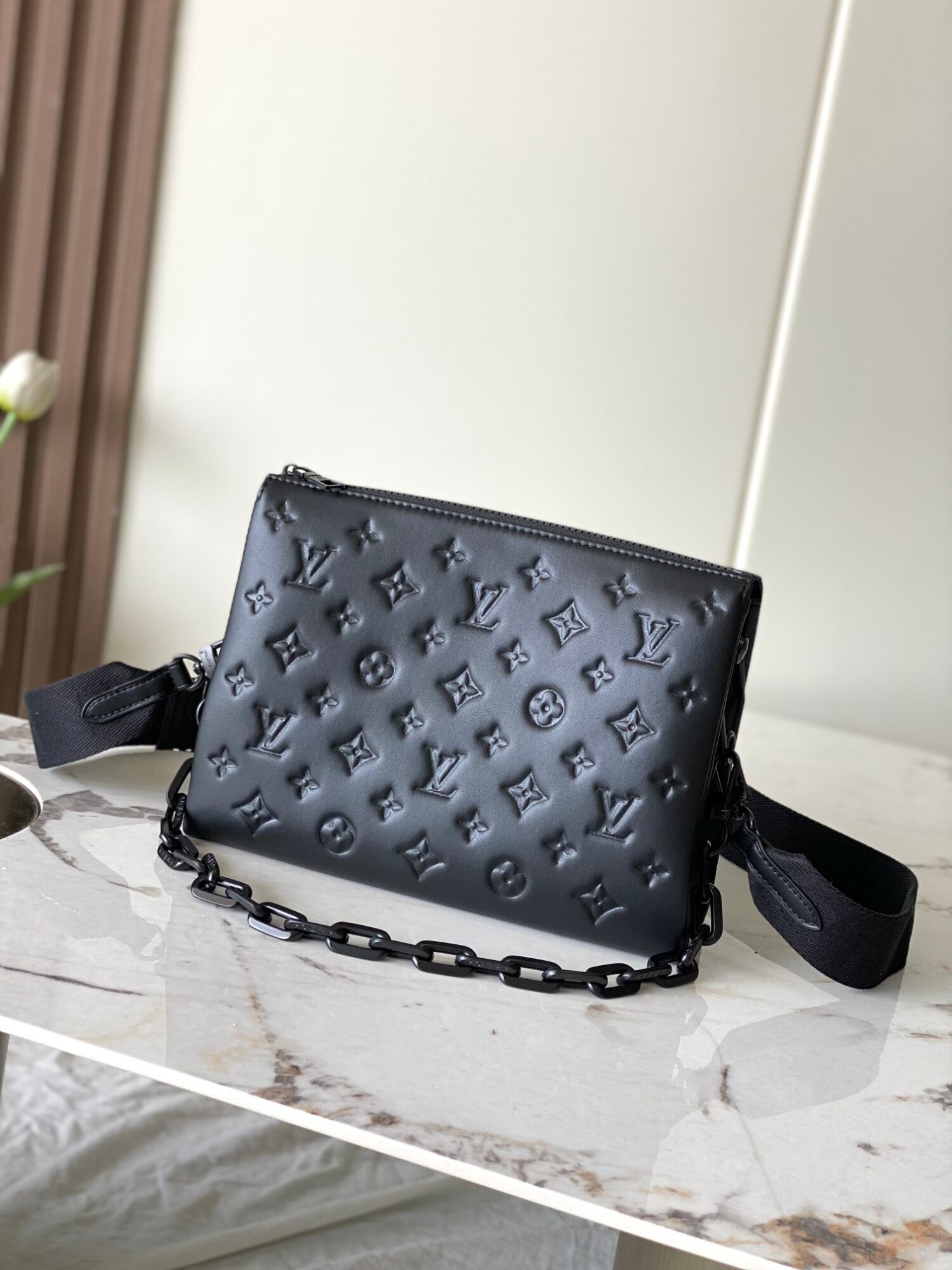 Louis Vuitton M11370 Black embossed leather bag with black chain.