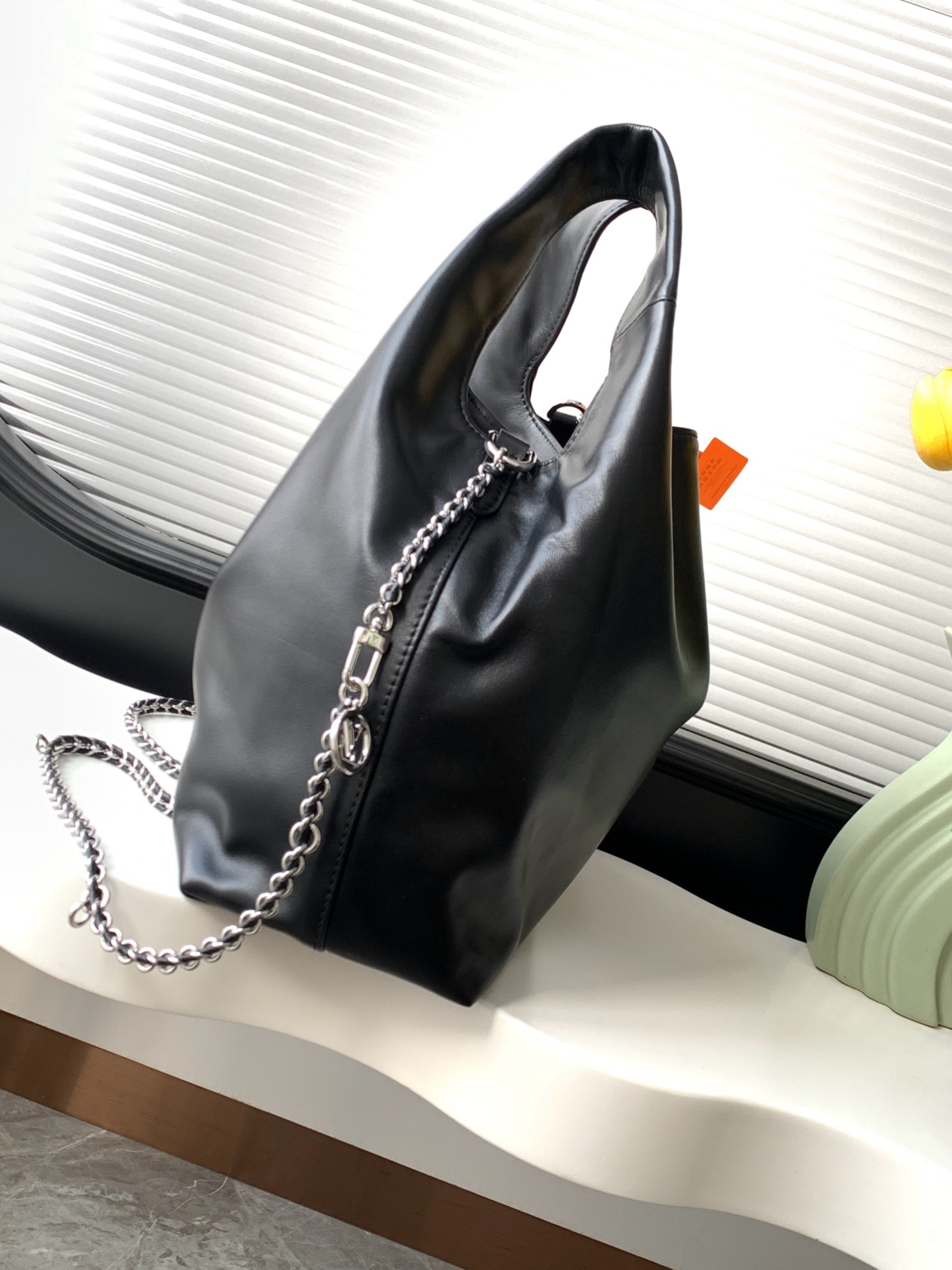 Louis Vuitton The M11266 Atlantis medium handbag is from the Dark Side collection.