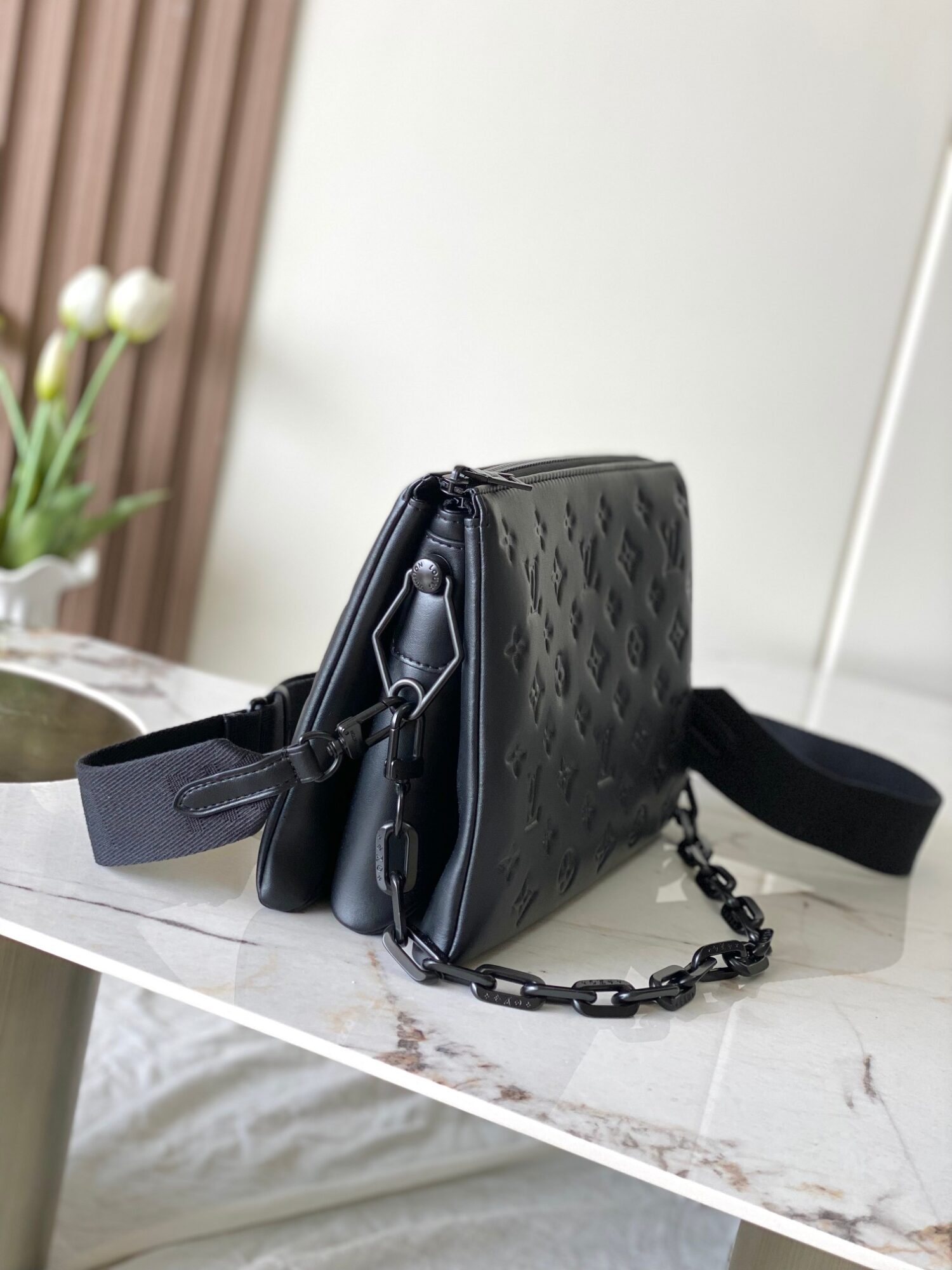 Louis Vuitton M11370 Black embossed leather bag with black chain.