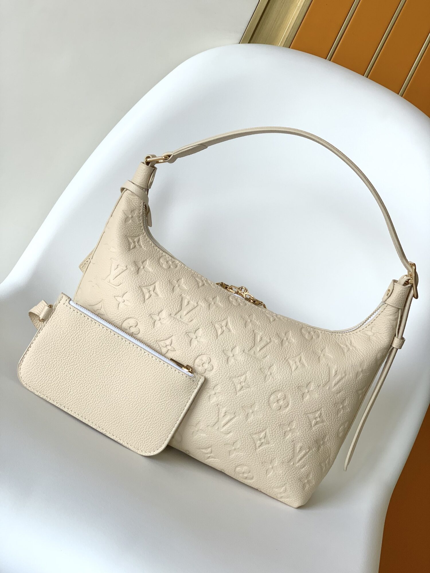 Louis Vuitton The Sac Sport handbag features a curved silhouette crafted from supple Monogram Empreinte embossed leather.