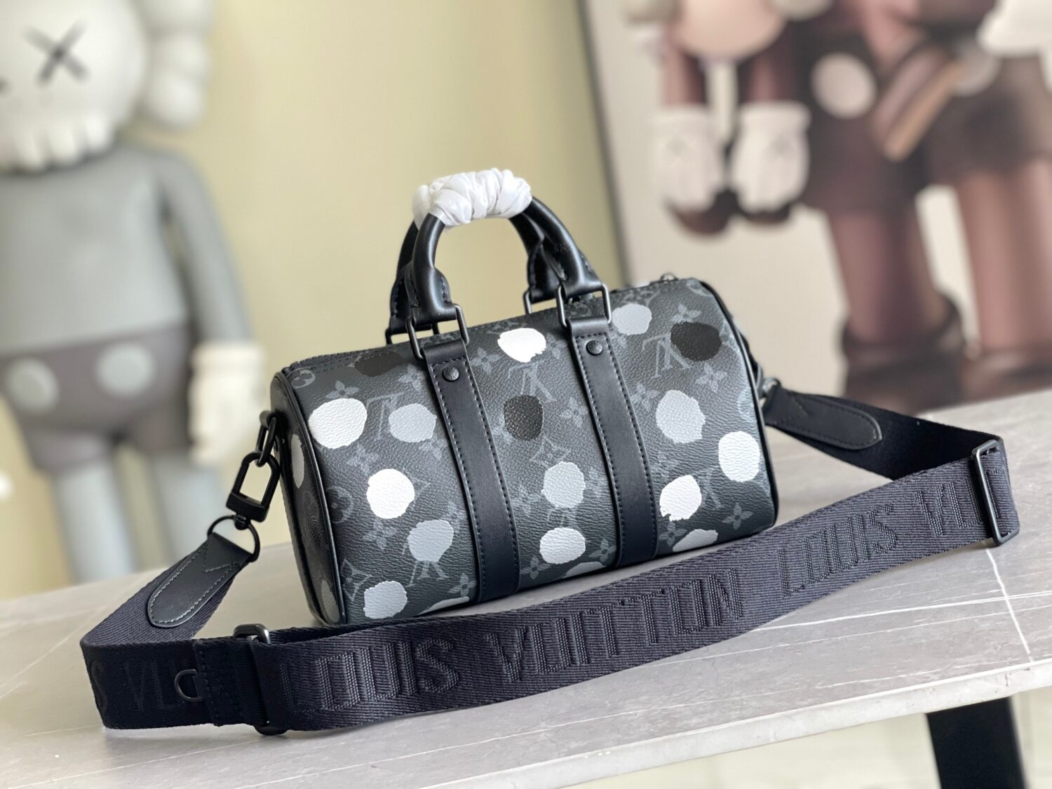 Louis Vuitton M46406 Black Floral Polka Dot Yayoi Kusama Handbag: This handbag encapsulates the classic silhouette of a travel bag and is crafted from embossed leather.