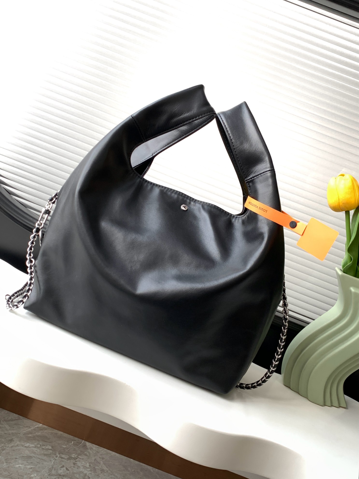 Louis Vuitton The M11266 Atlantis medium handbag is from the Dark Side collection.