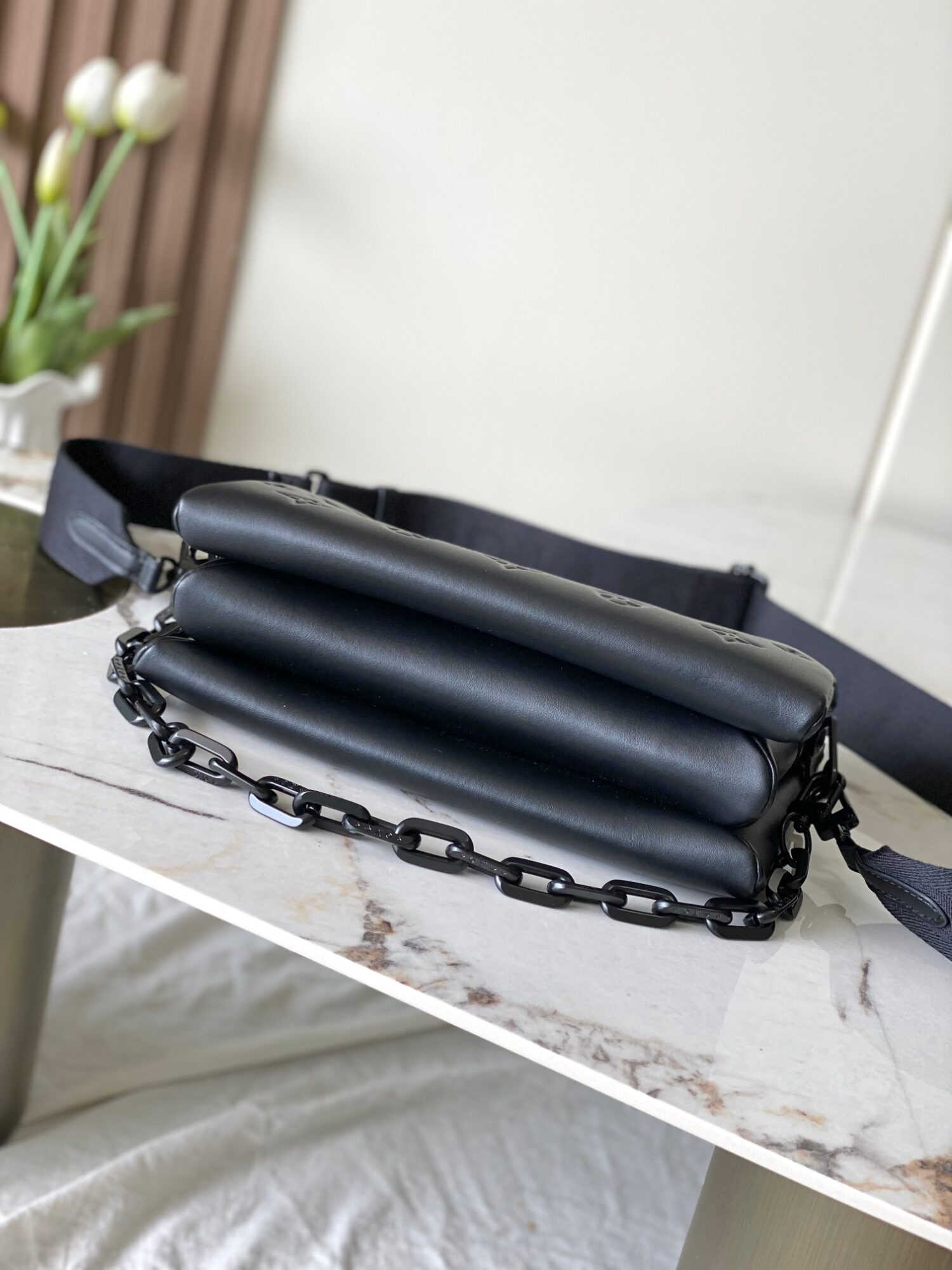 Louis Vuitton M11370 Black embossed leather bag with black chain.