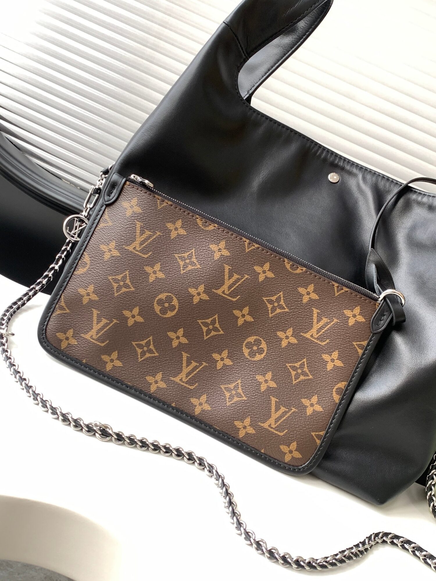 Louis Vuitton The M11266 Atlantis medium handbag is from the Dark Side collection.