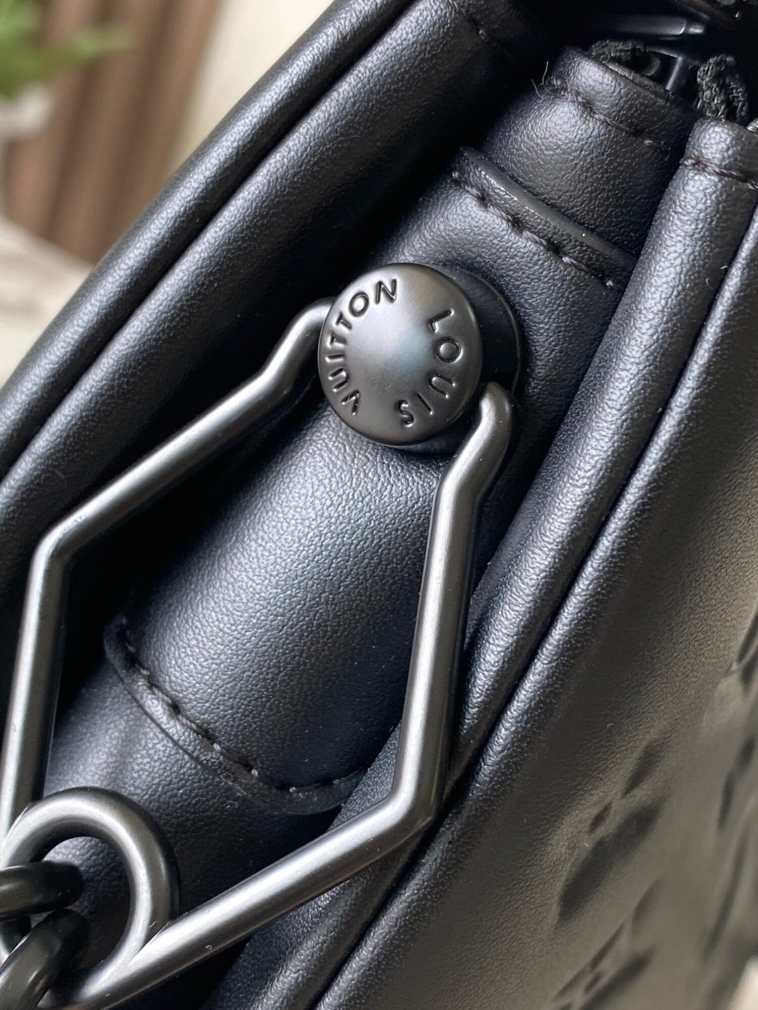 Louis Vuitton M11370 Black embossed leather bag with black chain.