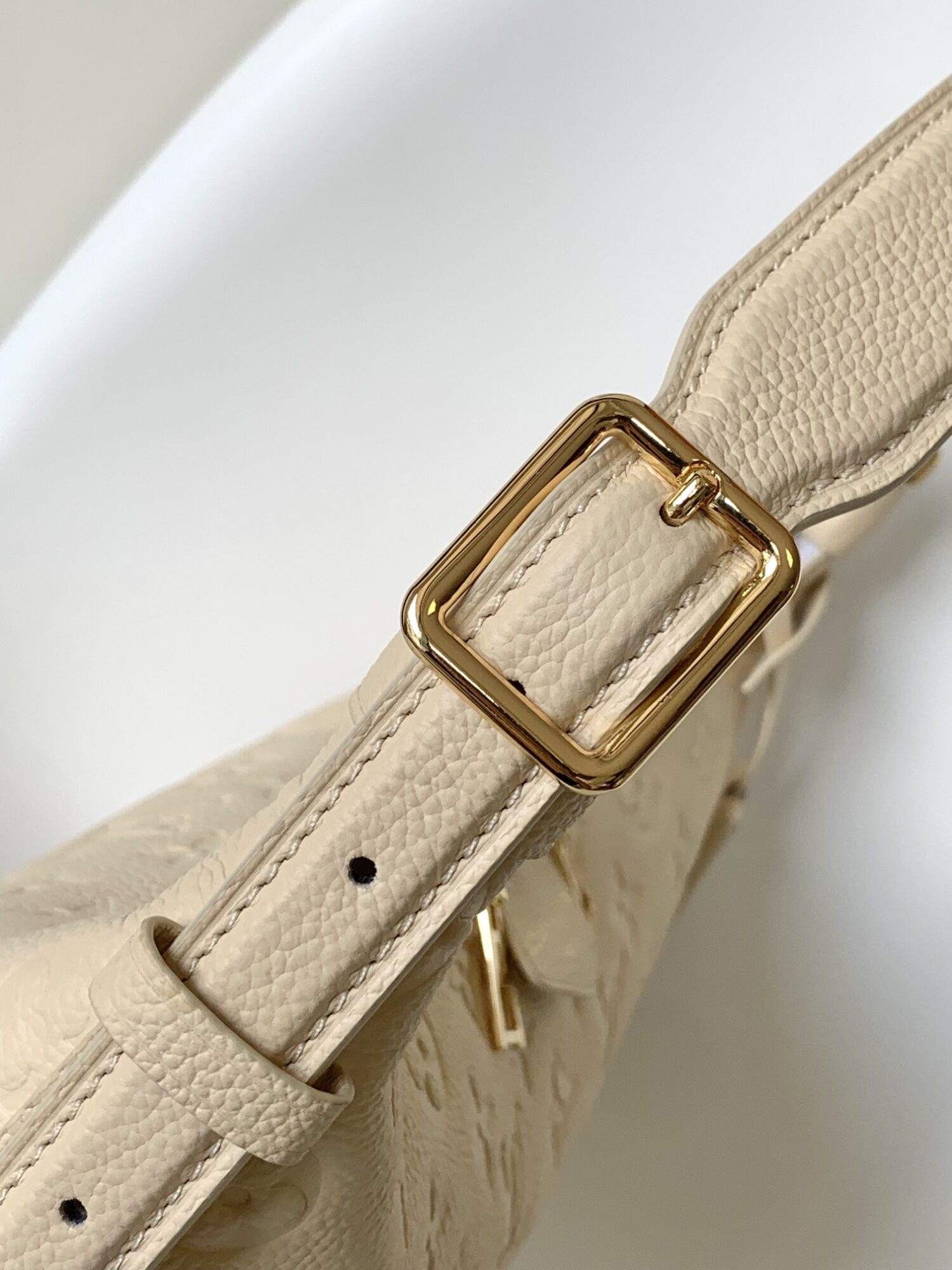 Louis Vuitton The Sac Sport handbag features a curved silhouette crafted from supple Monogram Empreinte embossed leather.