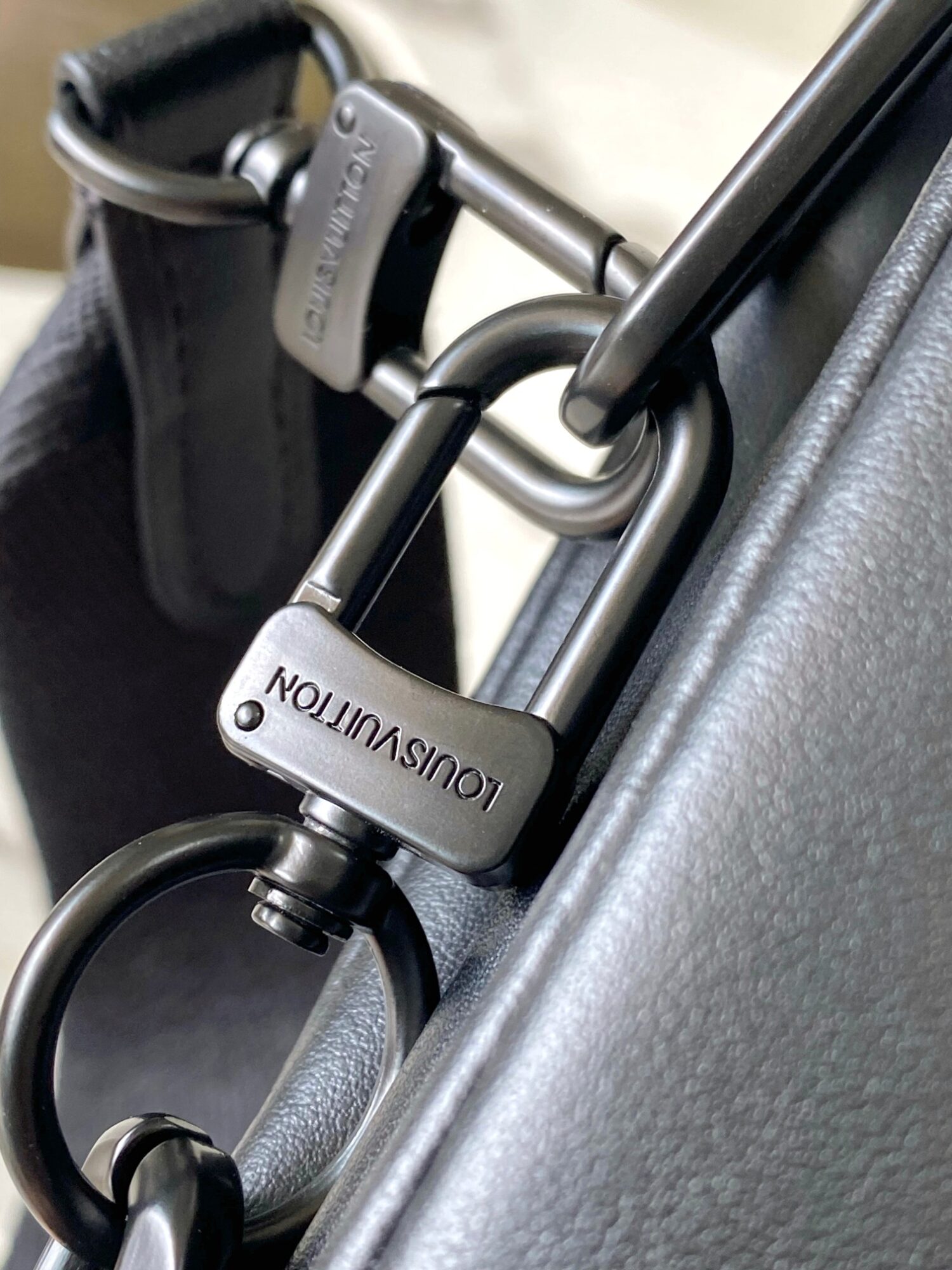 Louis Vuitton M11370 Black embossed leather bag with black chain.