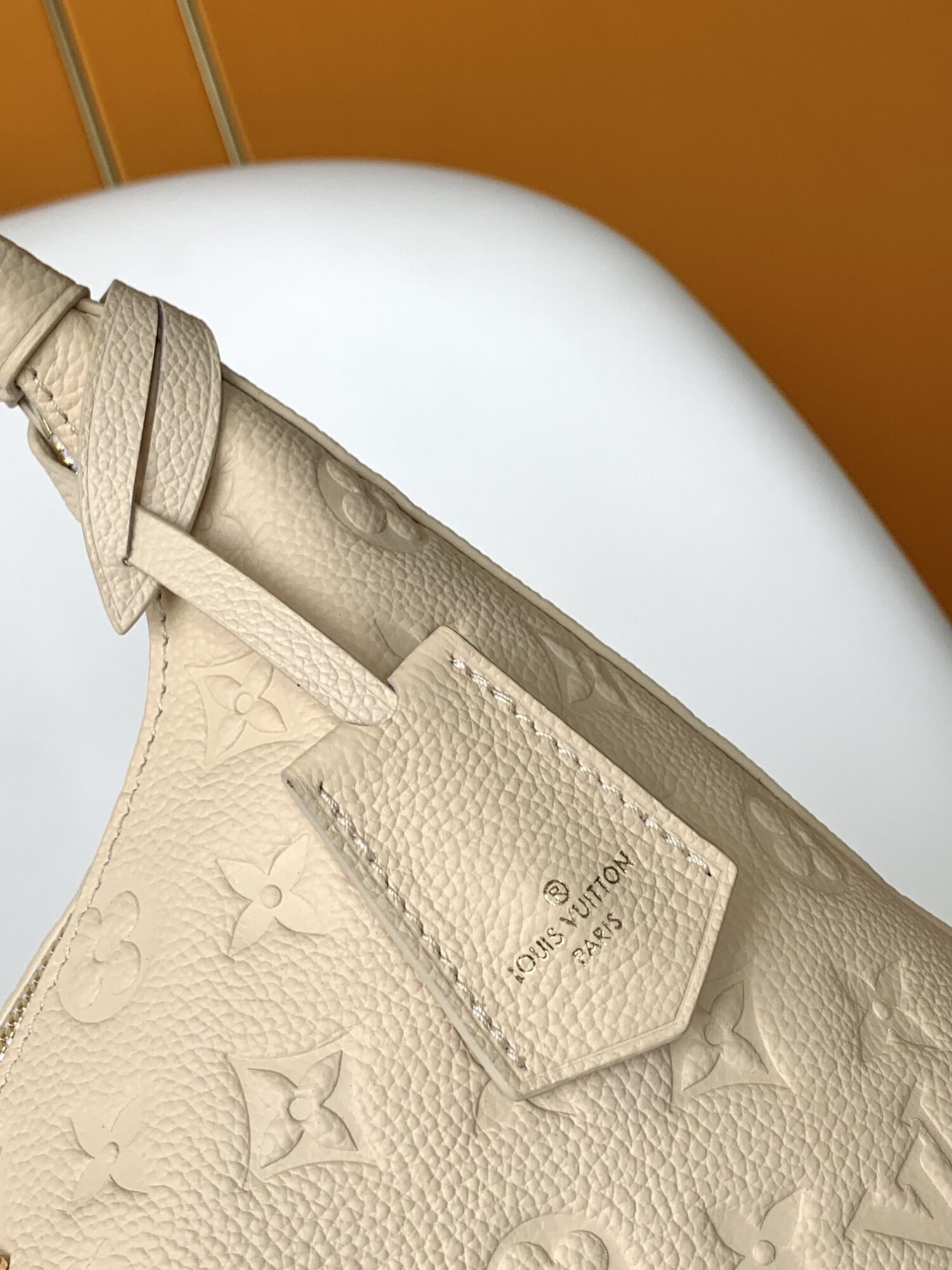 Louis Vuitton The Sac Sport handbag features a curved silhouette crafted from supple Monogram Empreinte embossed leather.