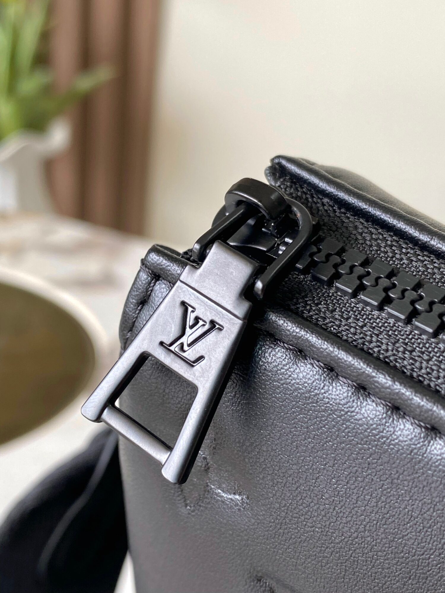 Louis Vuitton M11370 Black embossed leather bag with black chain.