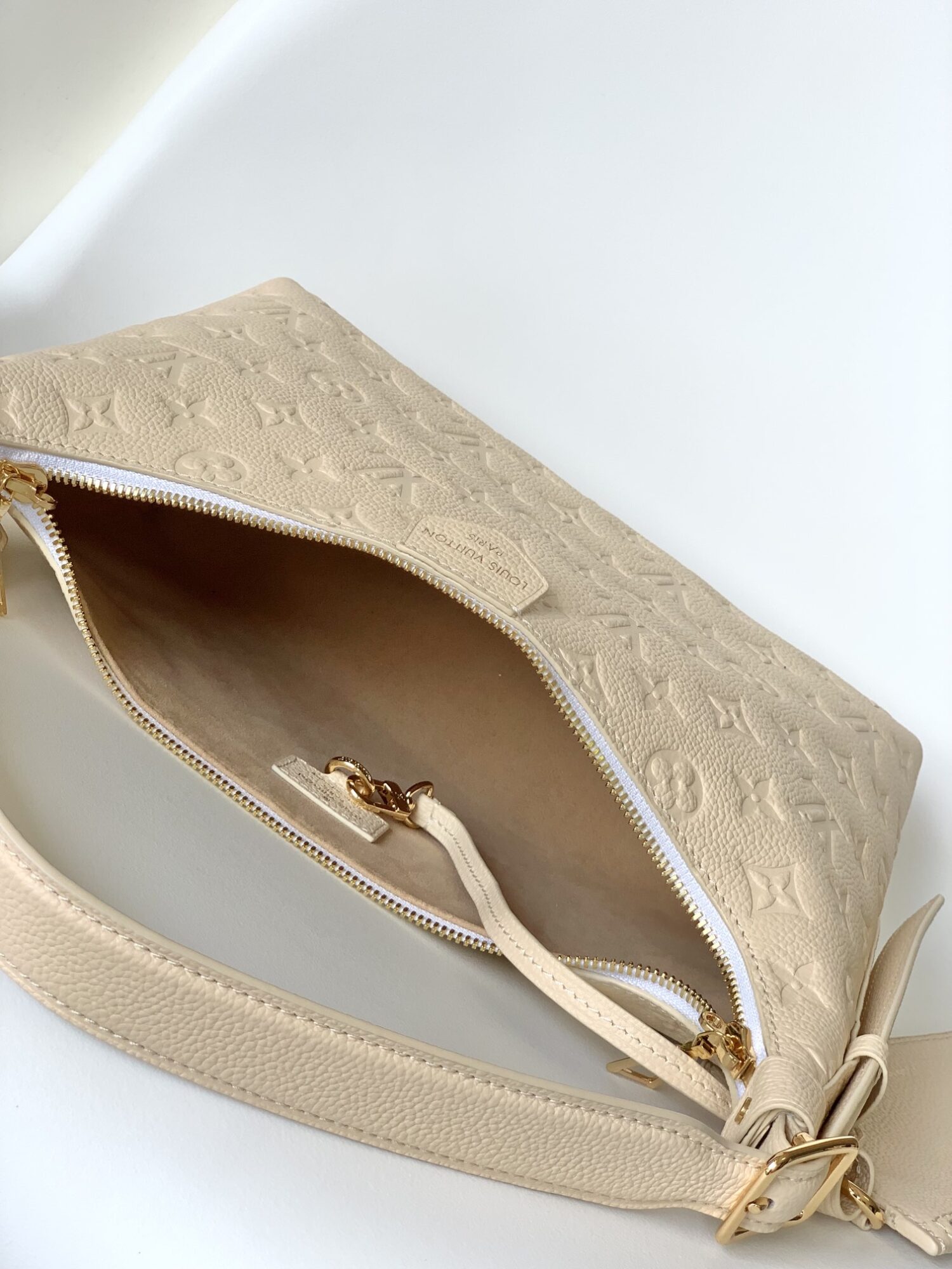 Louis Vuitton The Sac Sport handbag features a curved silhouette crafted from supple Monogram Empreinte embossed leather.