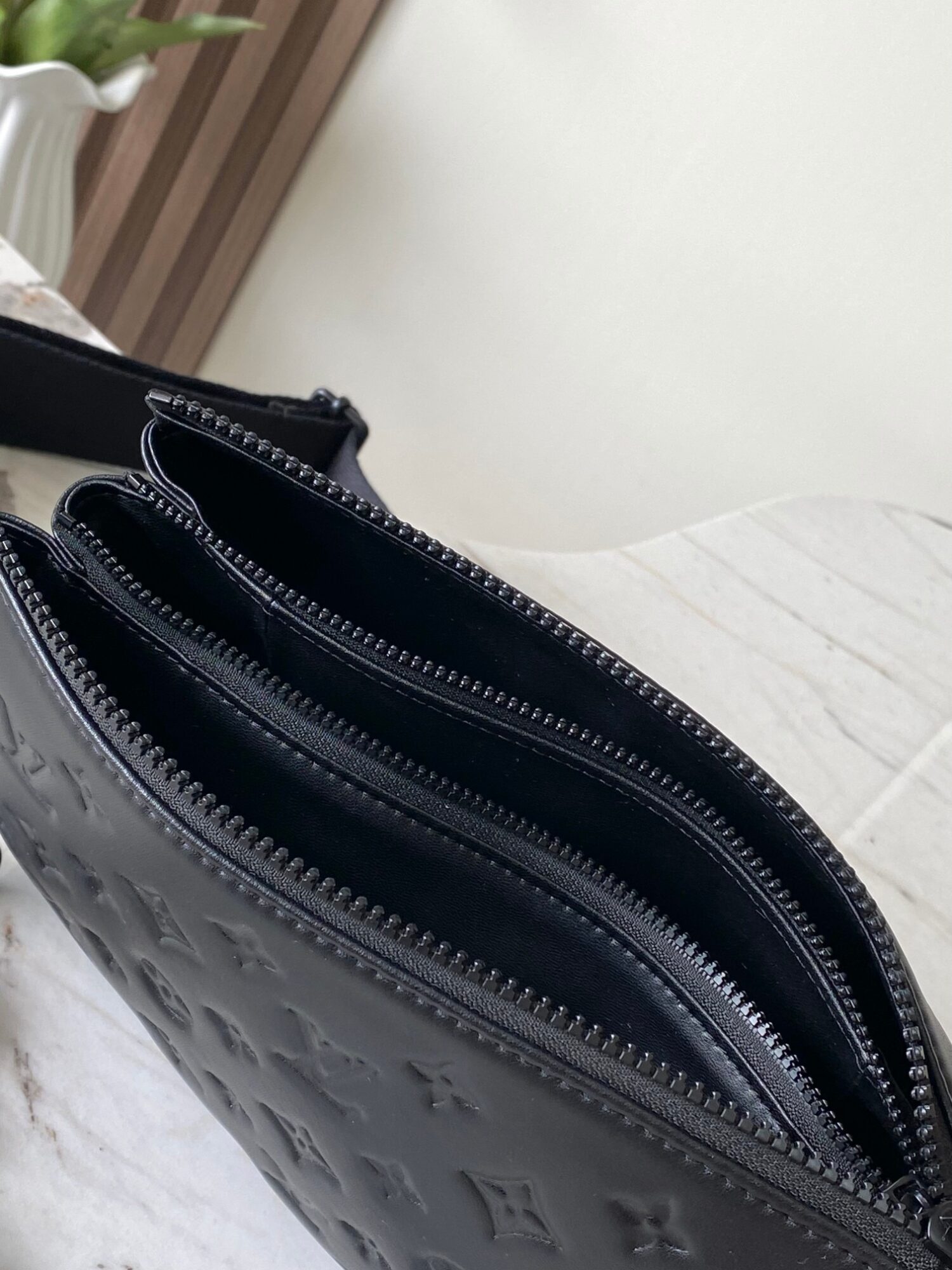 Louis Vuitton M11370 Black embossed leather bag with black chain.