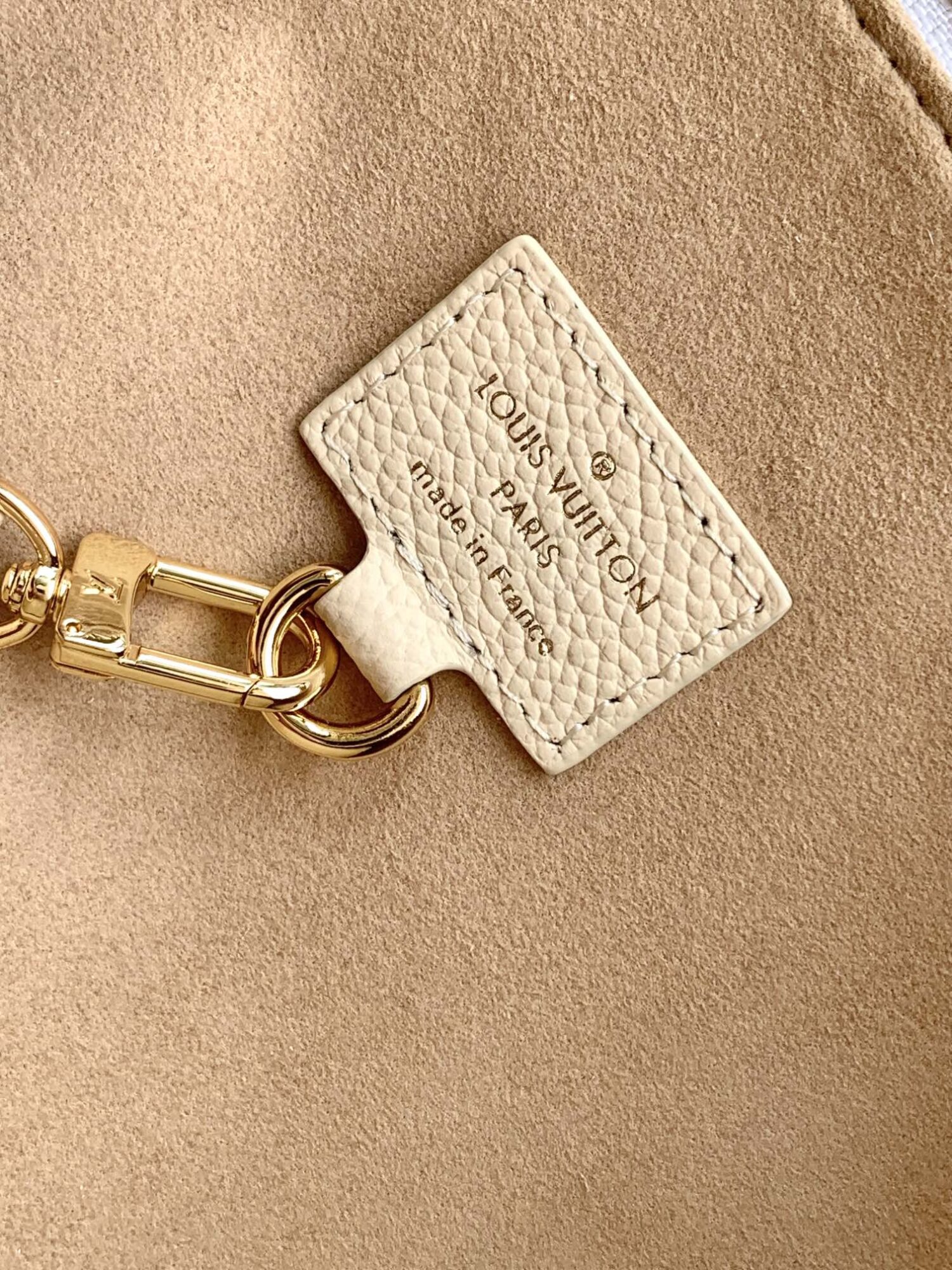 Louis Vuitton The Sac Sport handbag features a curved silhouette crafted from supple Monogram Empreinte embossed leather.