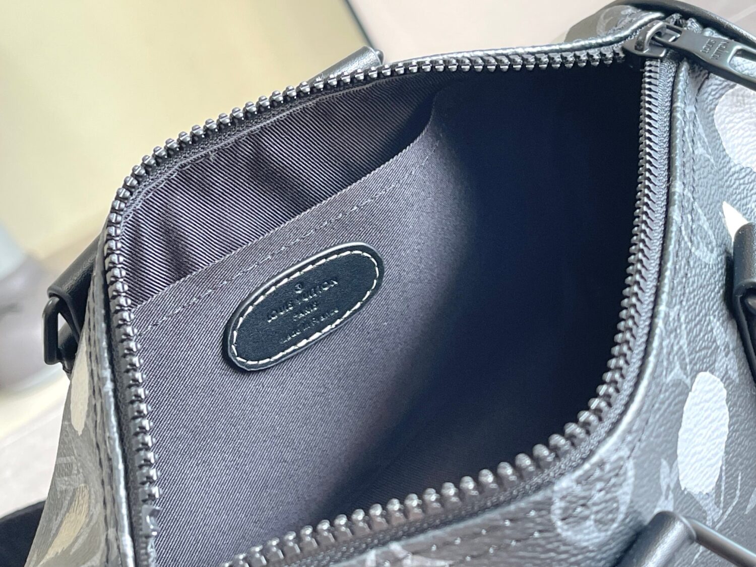 Louis Vuitton M46406 Black Floral Polka Dot Yayoi Kusama Handbag: This handbag encapsulates the classic silhouette of a travel bag and is crafted from embossed leather.