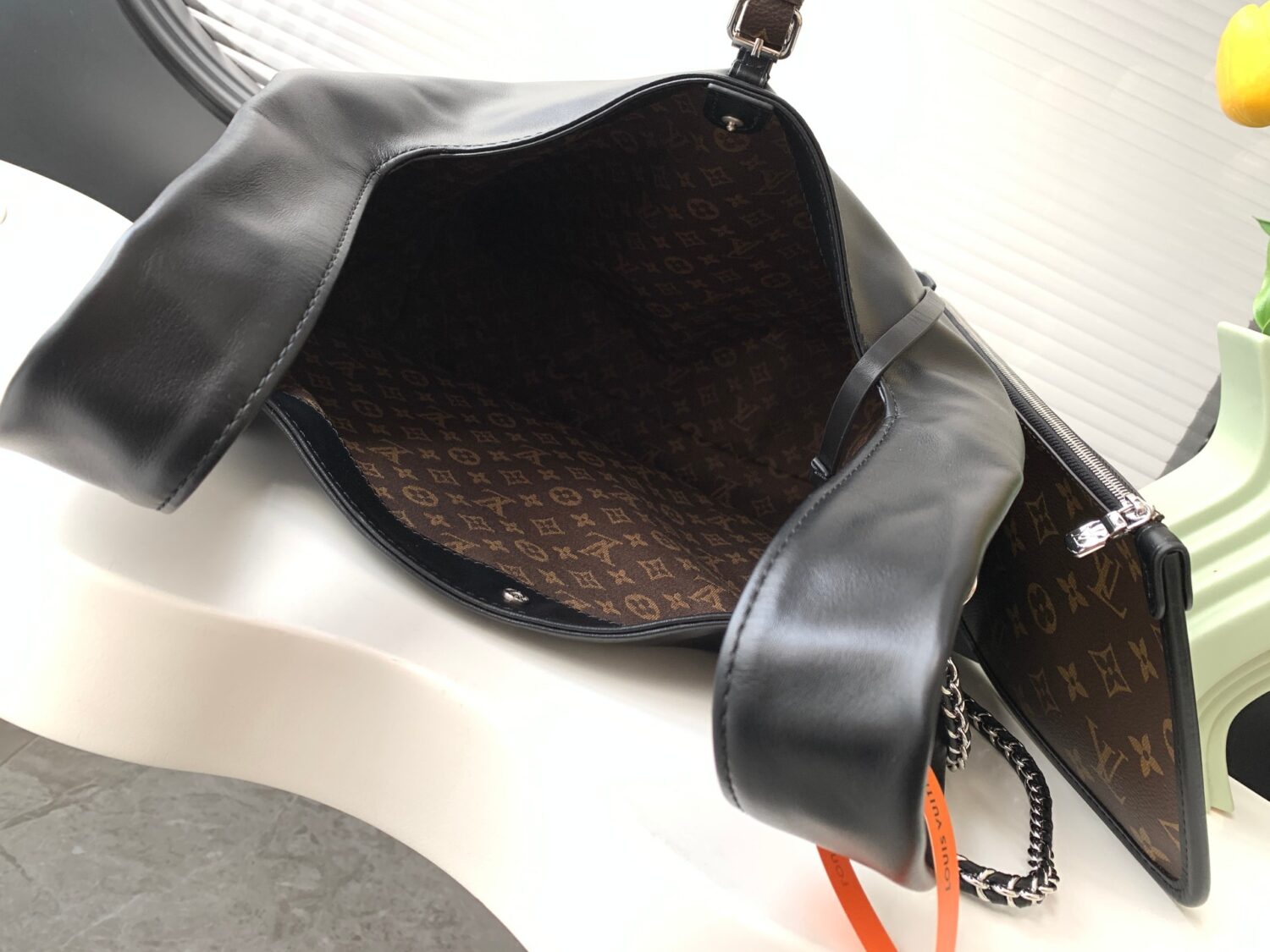 Louis Vuitton The M11266 Atlantis medium handbag is from the Dark Side collection.