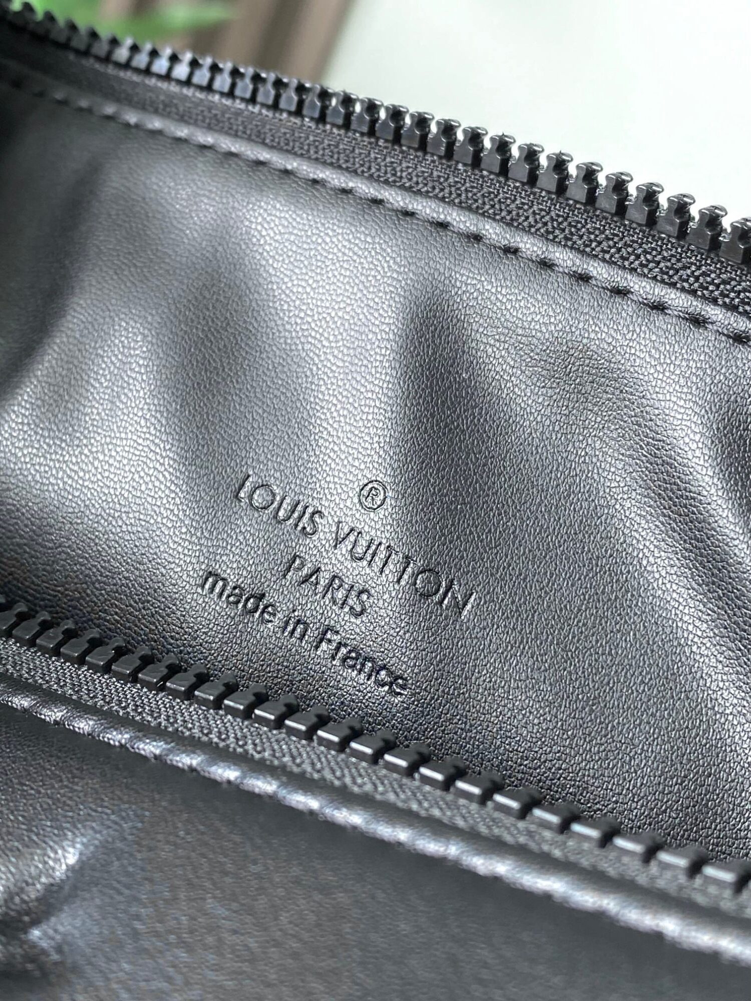 Louis Vuitton M11370 Black embossed leather bag with black chain.